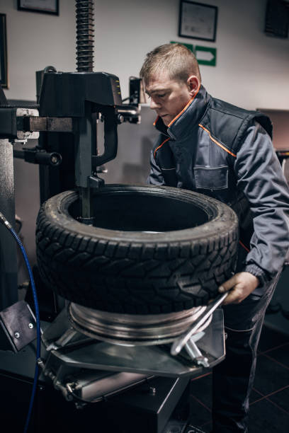 istock Mechanic putting tire on wheel rim 1884373914