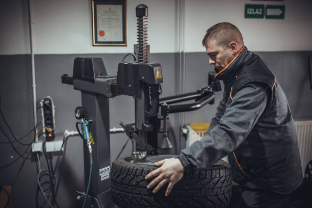 istock Mechanic putting tire on wheel rim 1884377120