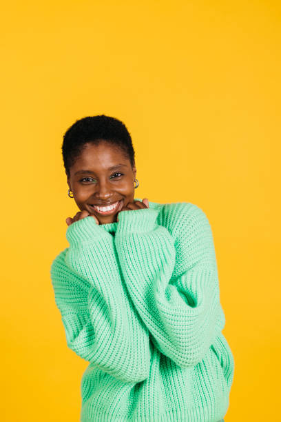 istock Woman in a studio with yellow background. 1884382295