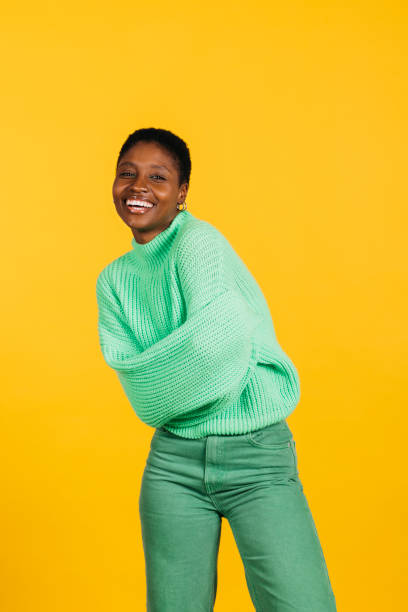 istock Woman in a studio with yellow background. 1884382301