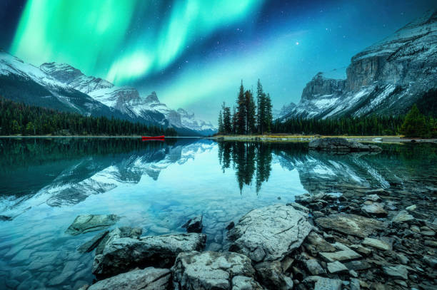 Spirit Island with aurora borealis glowing in the night sky on Maligne Lake at Jasper national park, Canada Beautiful landscape of Spirit Island with aurora borealis glowing in the night sky on Maligne Lake at Jasper national park, Alberta, Canada canadian rockies stock pictures, royalty-free photos & images