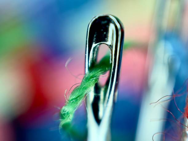 istock Close up of sewing needle with green thread 1884436803