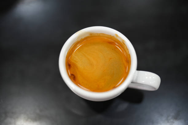 istock A cup of black coffee on and black background. Top view with copy space. 1884437845