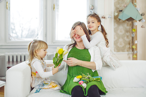 Family giving floral gifts to grandmother