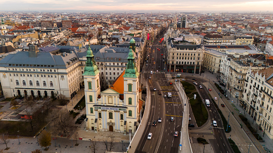 From a Lofty Drone Perspective,the Parish Church Graces the Budapest Cityscape in Hungary. This High Angle View Captures the Architectural Splendor of the Church,Harmonizing with the Urban Tapestry Below,Creating a Captivating Scene of Cultural Richness