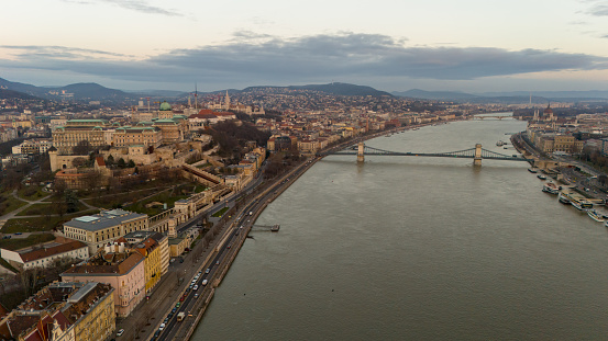An Aerial Drone Captures the Iconic Szechenyi Chain Bridge Spanning the Danube River,Weaving Through the Enchanting Cityscape of Budapest,Hungary. A Breathtaking Perspective of Architectural Elegance and Urban Charm