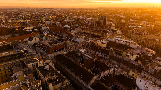 From Above,a Drone Captures the Bustling Cityscape of Budapest,Hungary,Bathed in the Warm Glow of Sunset. As the City Comes to Life,the Aerial View Reveals a Vibrant Tapestry of Urban Energy