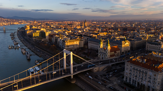 Capturing the Enchanting Allure of Budapest,Hungary,an Aerial Drone Unveils the Elisabeth Bridge Gracefully Spanning the Danube River Amidst the Cityscape During the Magical Moments of Sunset. The Scene Bathes In Warm Hues Blending with Architectural Elegance