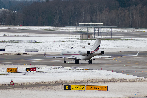Zurich, Switzerland, December 6, 2023 CS-GLD Bombardier Global 6000 aircraft is taxiing to its parking position in the winter time