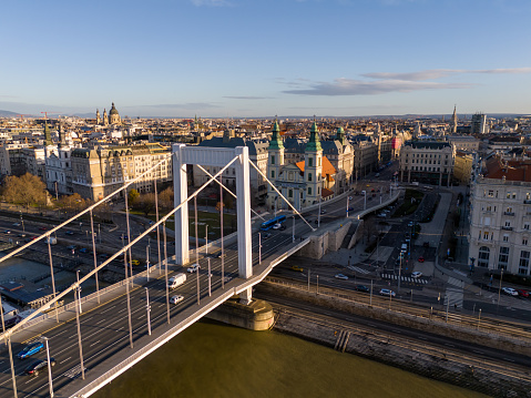 From a High Angle Drone Perspective,the Elisabeth Bridge Gracefully Spans the Danube River,Weaving Through the Enchanting Cityscape of Budapest,Hungary. Bathed in Sunlight,the Bridge Stands as a Testament to Architectural Beauty