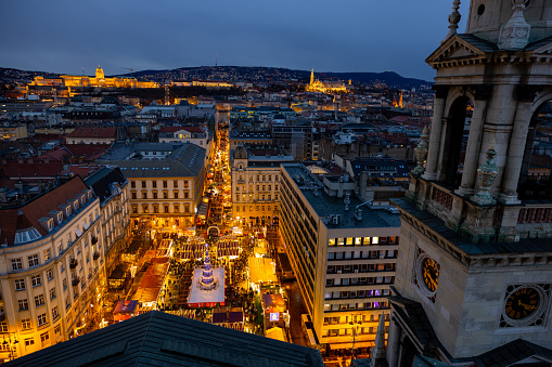 From a Mesmerizing Aerial Perspective,the Twinkling Lights of an Illuminated Christmas Market Come to Life Amidst the Enchanting Cityscape of Budapest,Hungary. The Drone View Captures the Festive Spirit,Where the Warmth of Holiday Cheer and the Glow of Festive Decorations Create A Magical Scene In The Heart Of The Hungarian Capital During The Night
