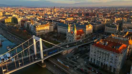 Embraced by the Soft Hues of Sunset,a Drone Captures the Timeless Allure of Budapest,Hungary. The Elisabeth Bridge,a Symbol of Architectural Splendor,Gracefully Spans the Cityscape,Bathed in the Warm Glow of the Evening Sun