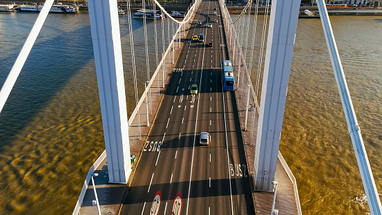 Sunny Day Commute,a High Angle Drone View Captures the Flow of Vehicles on the Elisabeth Bridge Over the Danube River in Budapest,Hungary. The Scene is Bathed in Sunlight,Showcasing the City's Bustling Energy and Scenic Charm