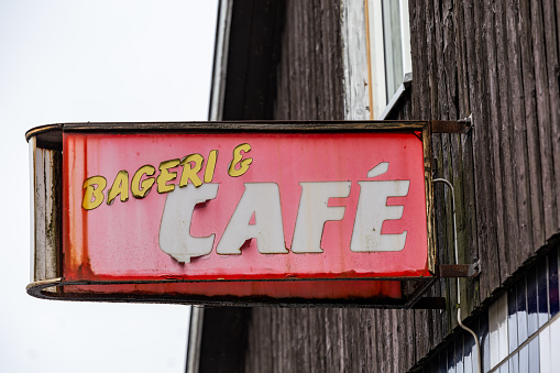 Billinge, Sweden An old antique sign over a closed bakeshop and cafe in Swedish.