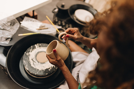 Close-up of a woman making a craft product of ceramic