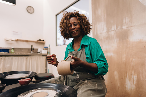 Portrait of a senior woman making a craft product of ceramic
