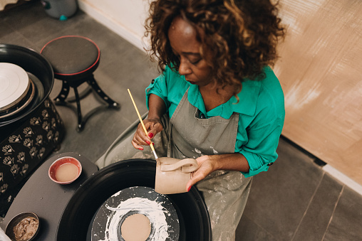 Senior woman making a craft product of ceramic