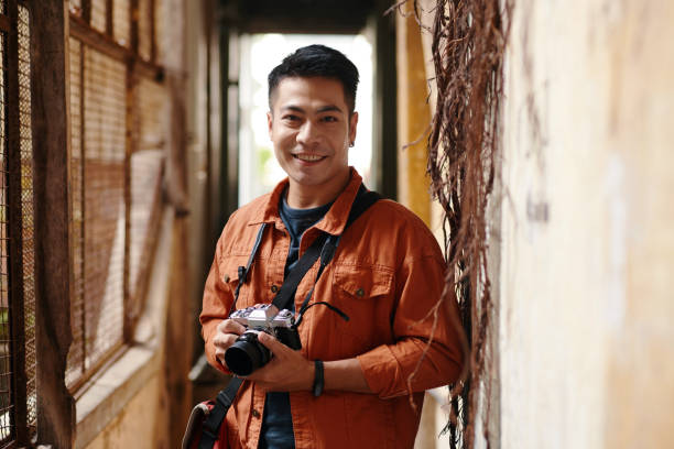 istock Smiling Photographer with Digital Camera 1884496254