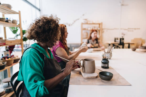 istock Senior woman making a craft product on a ceramics workshop 1884498362