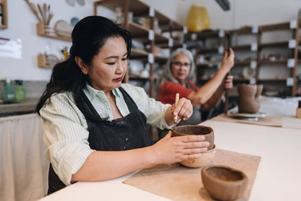 istock Mature woman making a craft product on a ceramics workshop 1884498367