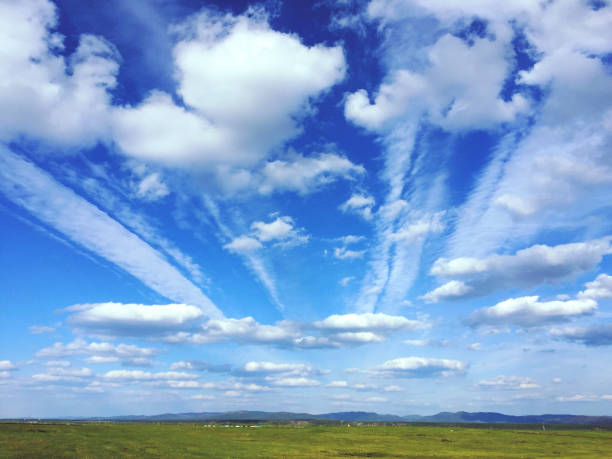 istock Beautiful summer landscape with blue sky, clouds and green meadow 1884515909