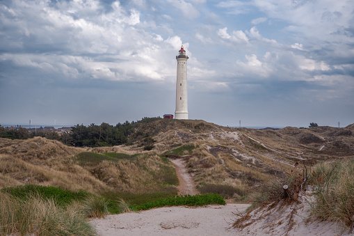 A Lighthouse on the Dunes of Northern Denmark at Lyngvig Fyr. Historic Lyngvig lighthouse in Jutland, North Sea coast in Denmark