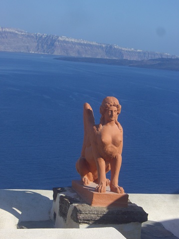 Santorini sculpture blue and white sea white city. Greek goddess Aphrodite.  Greek sculptures creations of the Attic sculptor Praxiteles on the island of Santorini, Greece