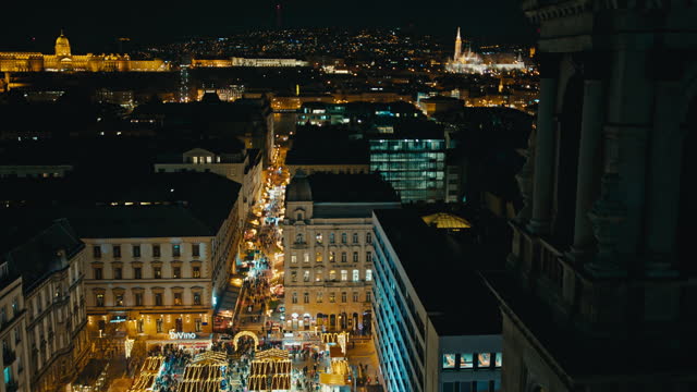 Aerial Shot of Illuminated Christmas Market and Cityscape of Budapest at Night in Hungary
