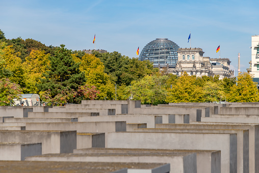 Berlin, Germany - September 25, 2023: A picture of the Reichstag Building and its dome overlooking the Memorial to the Murdered Jews of Europe.