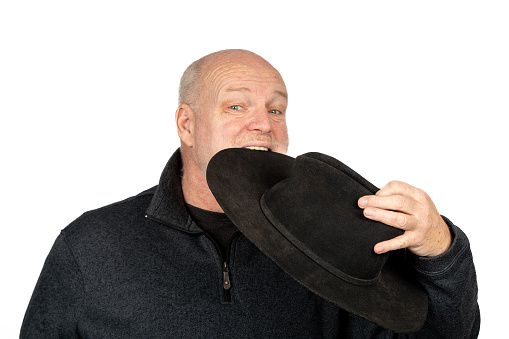 Quirky Farmer: Middle Aged Man Enjoying His Hat - Surreal Concept on White Background.