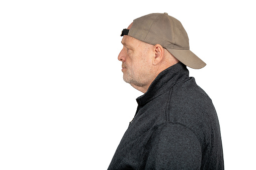 Uncertain Caucasian Middle-Aged Man in Backward Baseball Cap on White Background - Reflective Concept for Blue Collar Workers and Voters.