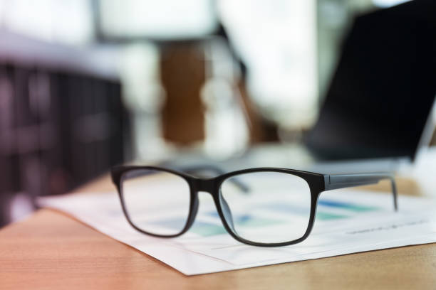istock Glasses lying on papers in office, work in office concept 1884657184