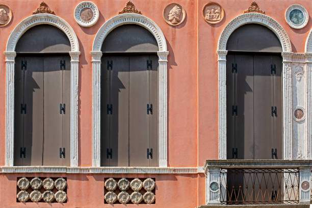 architectural Venetian semicircular windows on the red wall. trip to venice