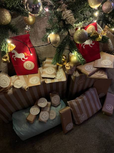 Advent calendar diy style with packages under Christmas tree for December gift tradition