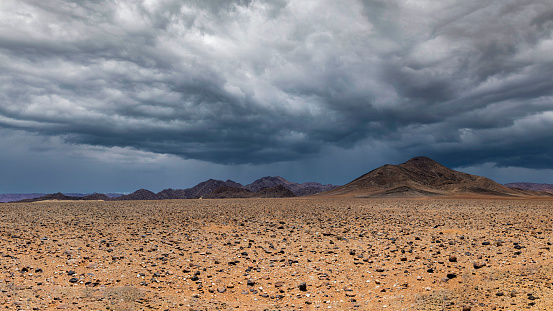 Storm clouds over a hill area in the desert area of Namibia
