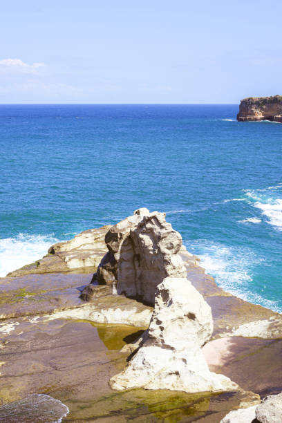 istock Beautiful beach with waves breaking on the rocks, Pacitan Klayer, East Java, Indonesia 1884712906