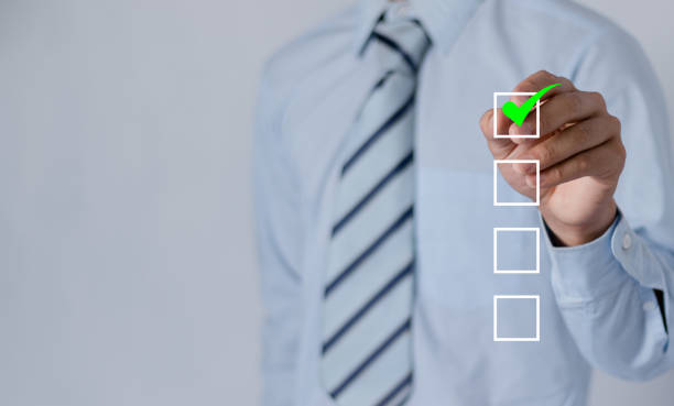 istock checklist concept businessman check mark on check box with check mark. 1884717259