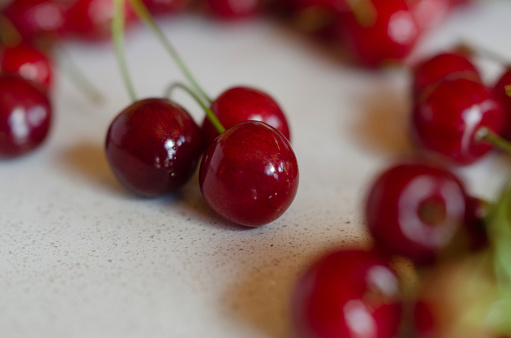 sweet and red cherries on marble table, fresh fruit taken close up