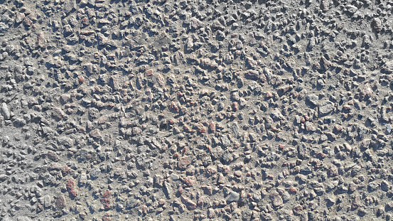 Asphalt road made of small stones, close-up texture
