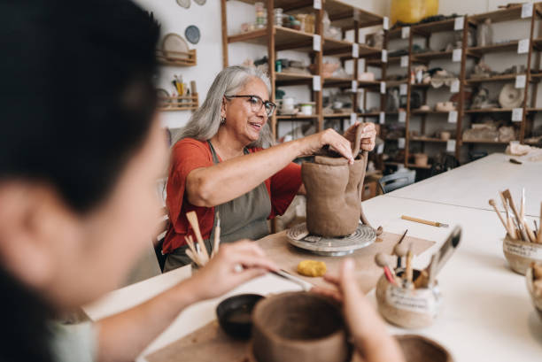 istock Senior woman making a craft product on a ceramics workshop 1884762279