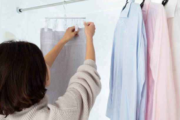 istock A woman hangs laundry in the bathroom. 1884763977