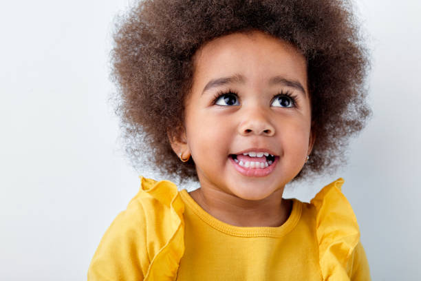 istock Cheerful little african girl isolated on white studio background, having fun 1884766748