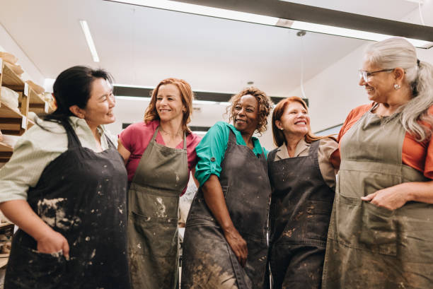 istock Potters friends talking and embracing on a ceramics workshop 1884766755