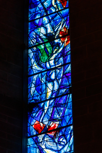 Zurich, Switzerland  - April 19, 2022: Stained glass window of the Protestant church Fraumunster designed by Marc Chagall in Zurich, Switzerland