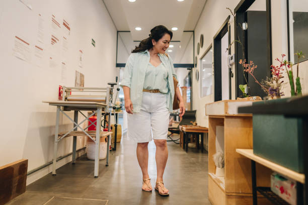 Mature woman walking on art studio