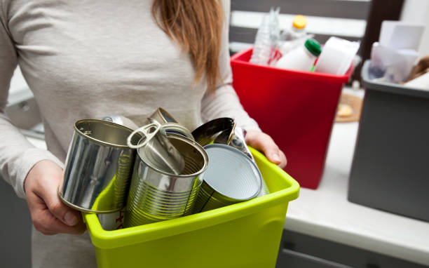 istock The woman is holding the full plastic box with assorted metal garbage 1884790424