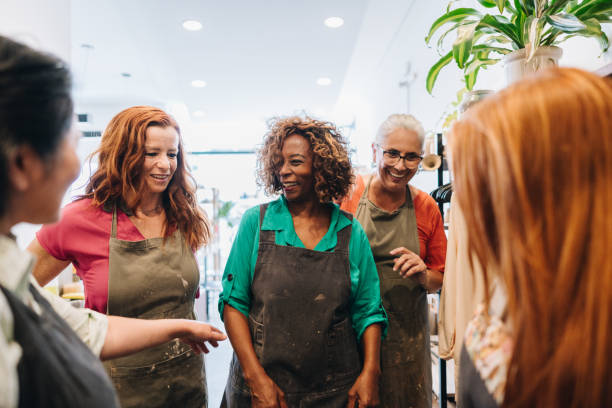 istock Friend potters talking on a ceramics workshop 1884795686