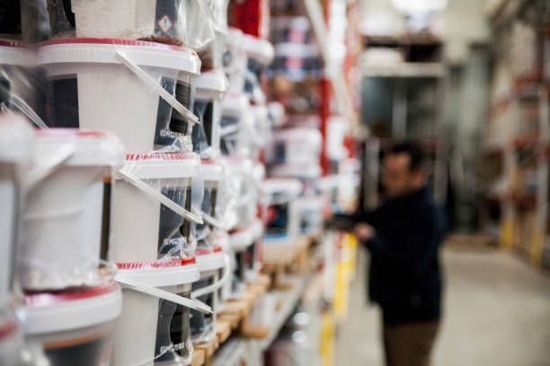 istock Warehouse Manager Counting Paints Stacked On Shelves 1884797781