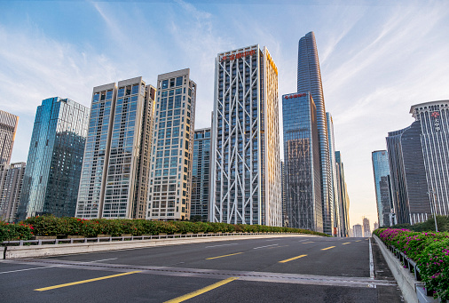 Empty asphalt road and modern city commercial buildings panorama in shenzhen