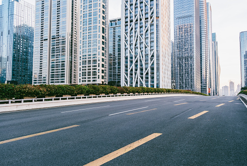 Empty asphalt road and modern city commercial buildings panorama in shenzhen